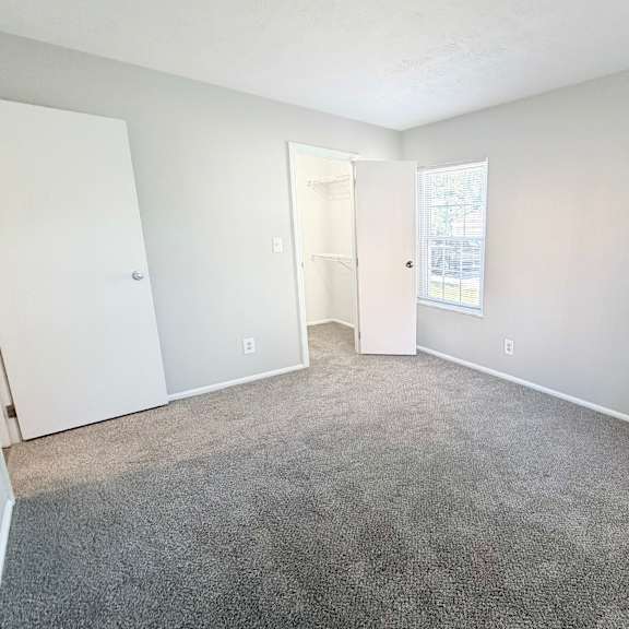 a room with a carpeted floor and white walls.