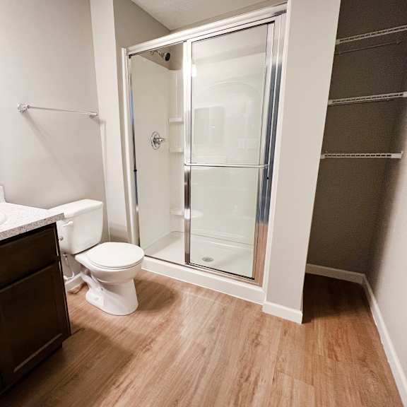 an empty bathroom with a shower toilet and sink  at brookfield village apartments, ohio, 43123