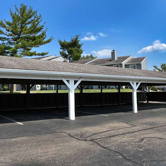 a covered parking lot with a building in the background at deercross apartments, cincinnati