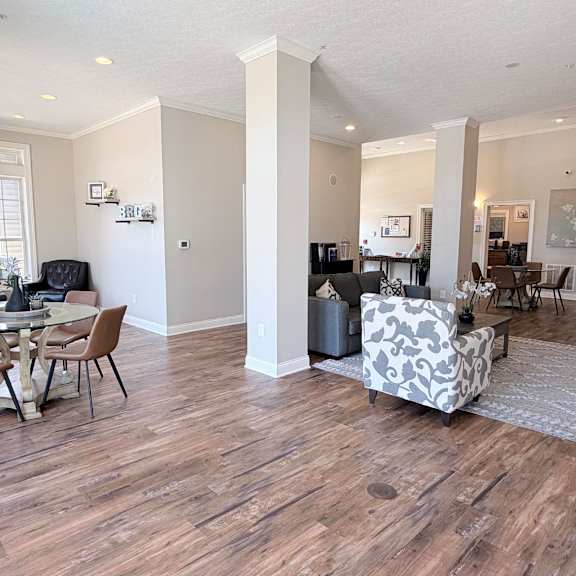 a living room with a dining table and chairs.