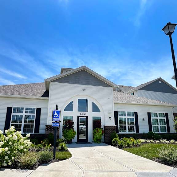 a white building with a blue sign in front of it at parkway trails, kentucky