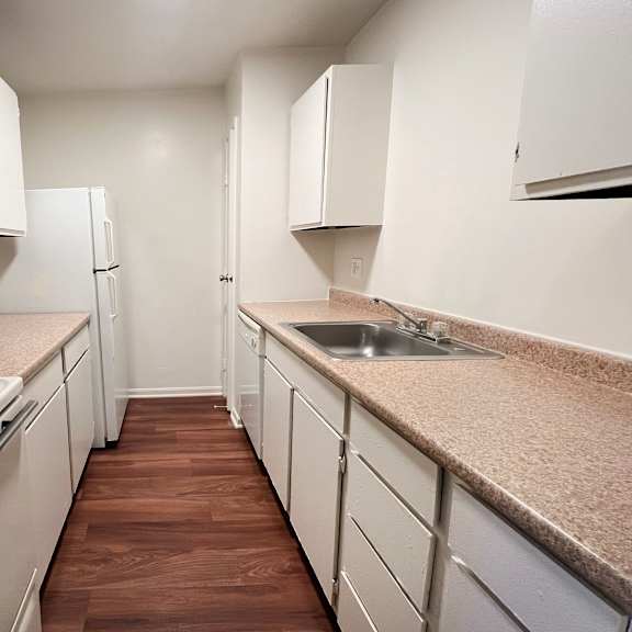 a kitchen with white appliances and cabinets.