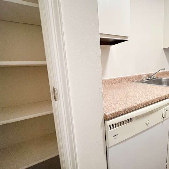 a kitchen with white cabinets and a sink.