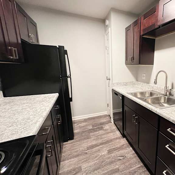 a kitchen with granite countertops and a stainless steel sink at crown crossing apartments, amelia, 45102