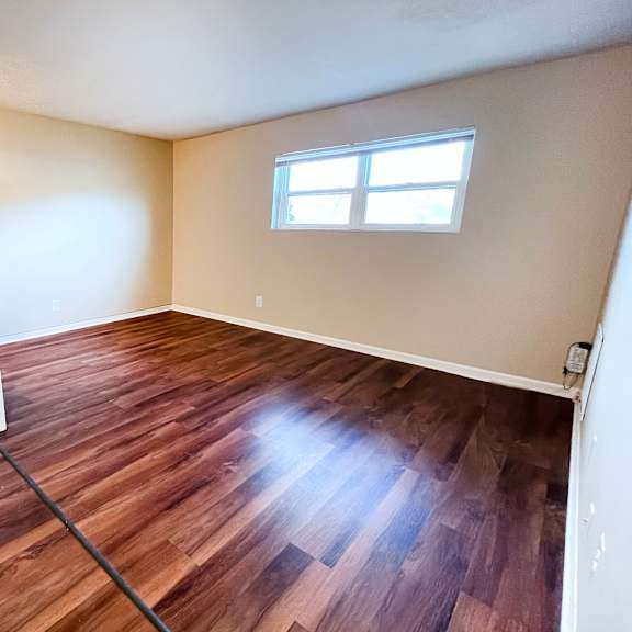 a room with wooden floors and a window at crown crossing apartments, amelia, oh, 45102