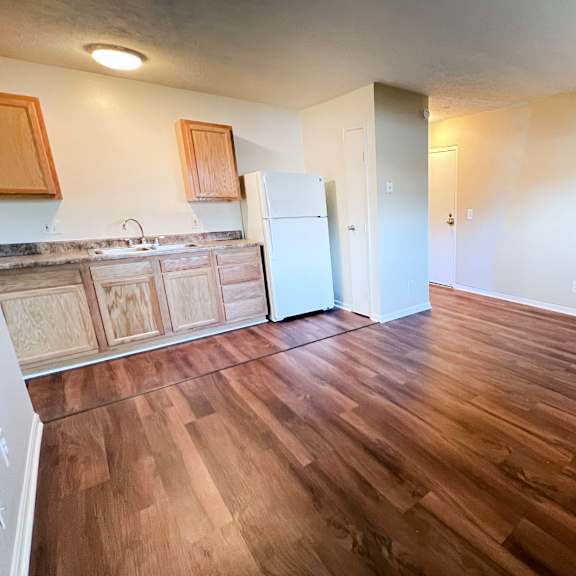 a kitchen with wooden floors and a white refrigerator at crown crossing apartments, amelia, ohio, 45102