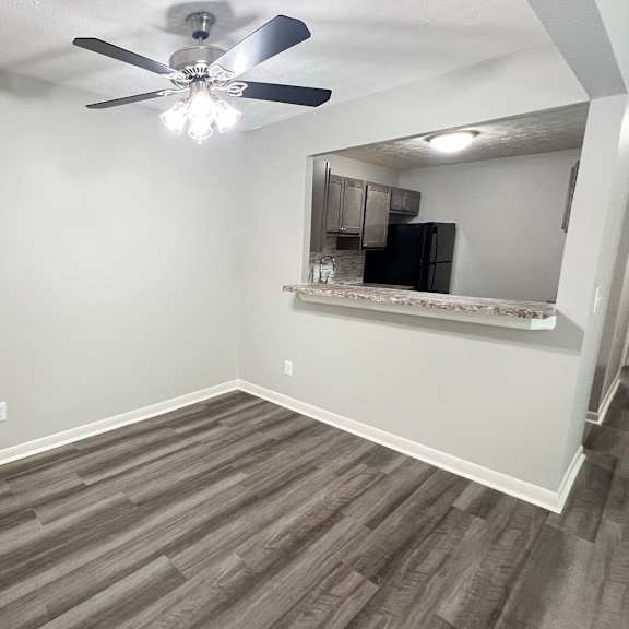 a living room with wood flooring and a ceiling fan at fox run apartments, cincinnati