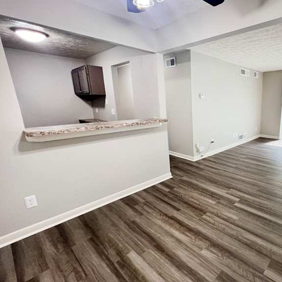 an empty living room with hardwood flooring and a window at fox run apartments, cincinnati