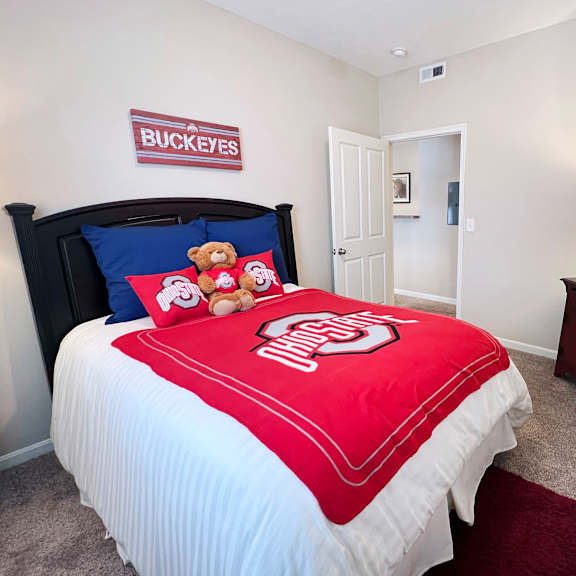 a bedroom with a bed, nightstand, and a