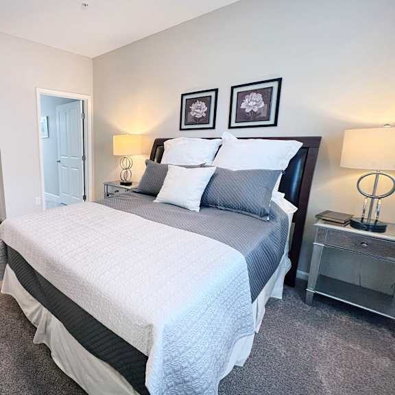 a bedroom with a large bed and two nightstands.