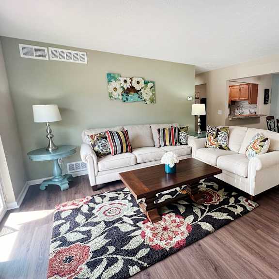 a living room with two couches and a coffee table at fox run apartments, cincinnati
