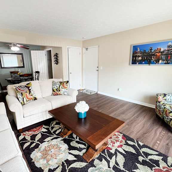 a living room with couches and a coffee table at fox run apartments, cincinnati