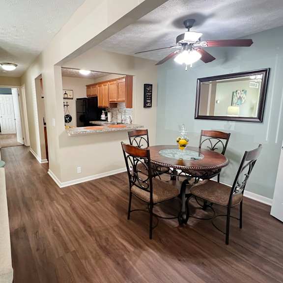 a living room and dining room with a couch and a table at fox run apartments, cincinnati