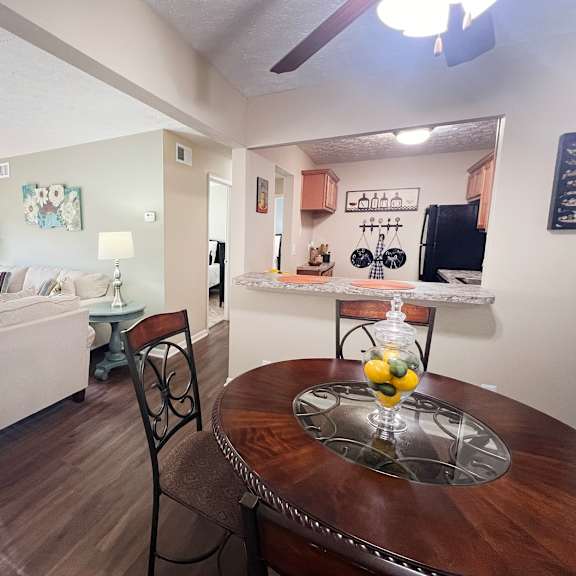 a living room and dining room with a table and a couch at fox run apartments, cincinnati
