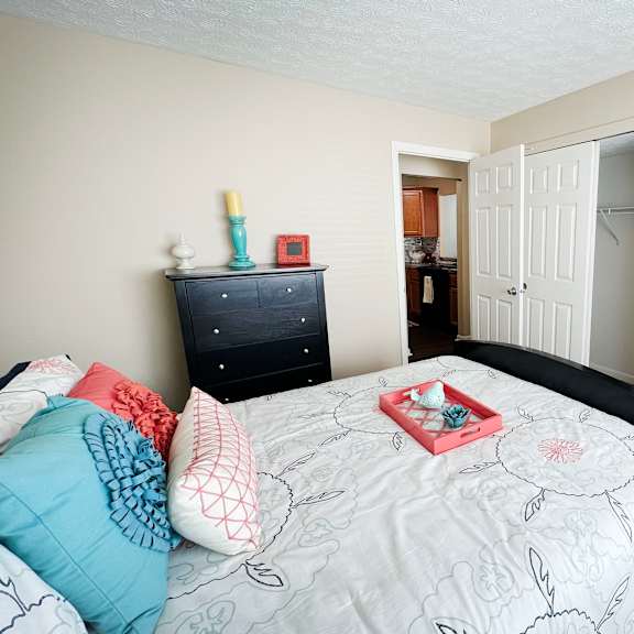 a bedroom with a bed and a closet  at fox run apartments, cincinnati, oh, 45236