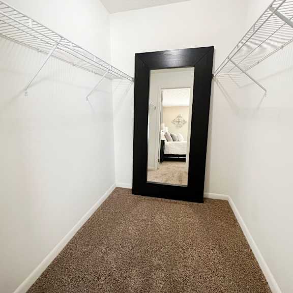a hallway with a mirror and white walls and carpet  at fox run apartments, cincinnati, oh, 45236