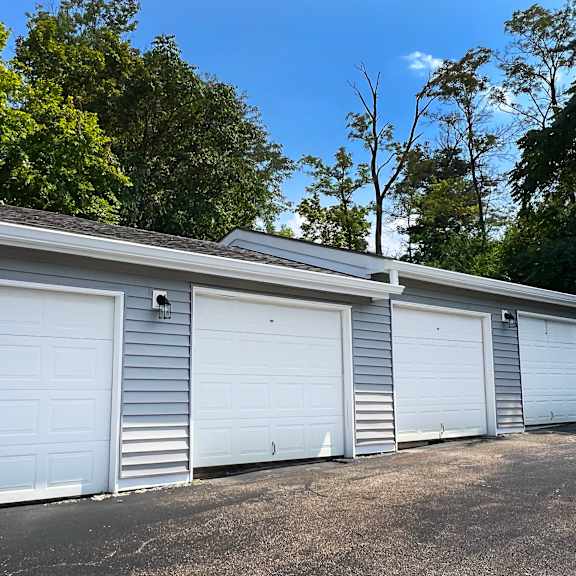 a row of three garage doors on the side of a building at deercross apartments, cincinnati, 45236