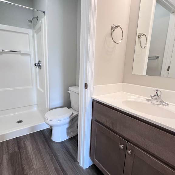 a white toilet and sink in a bathroom.