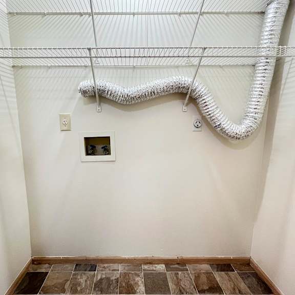 an empty bathroom with white walls and wires on the ceiling at eagle crest apartments, galloway