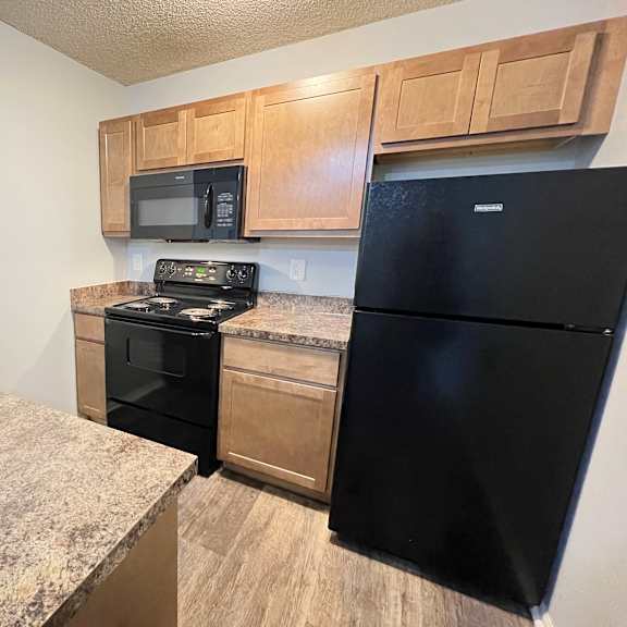 a kitchen with stainless steel appliances and granite counter tops at eagle crest apartments, ohio, 43119