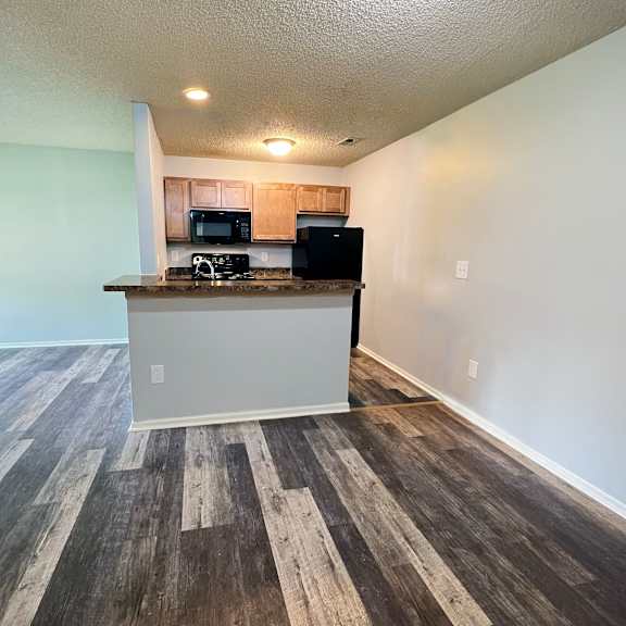 an empty living room and kitchen with a counter top at eagle crest apartments, galloway, ohio