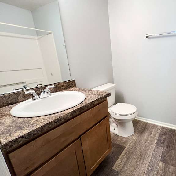 an empty bathroom with a sink and a toilet at eagle crest apartments, galloway, oh