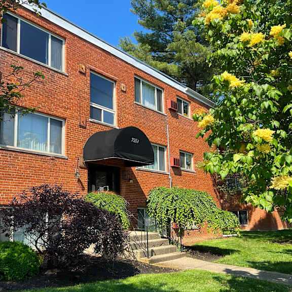 a brick apartment building with a black awning at crown court apartments, kentucky, 41042