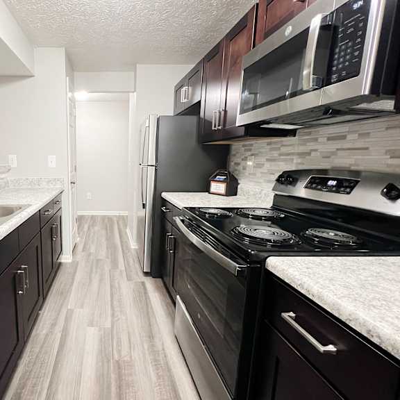 full kitchen with stainless steel appliances at the reserve at walnut creek apartments at the vinings apartments, ohio, 45245
