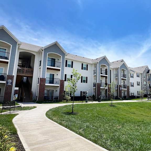 an exterior view of an apartment complex with grass and trees at parkway trails, florence, kentucky