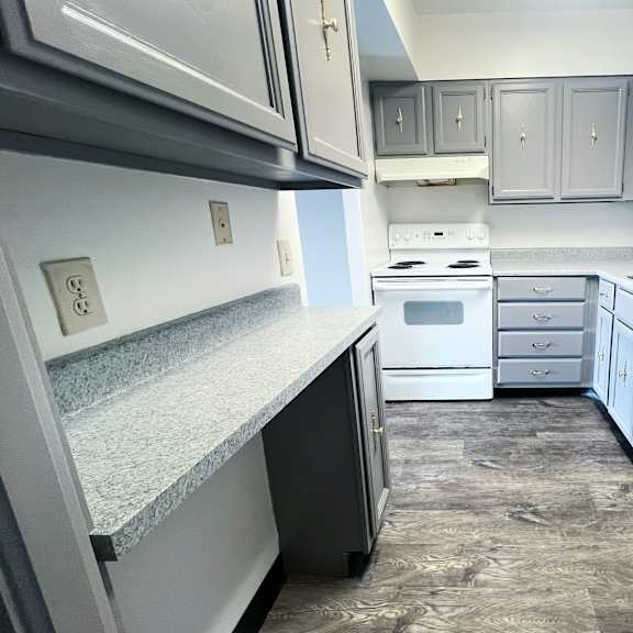 a kitchen with a white oven and a white dishwasher.