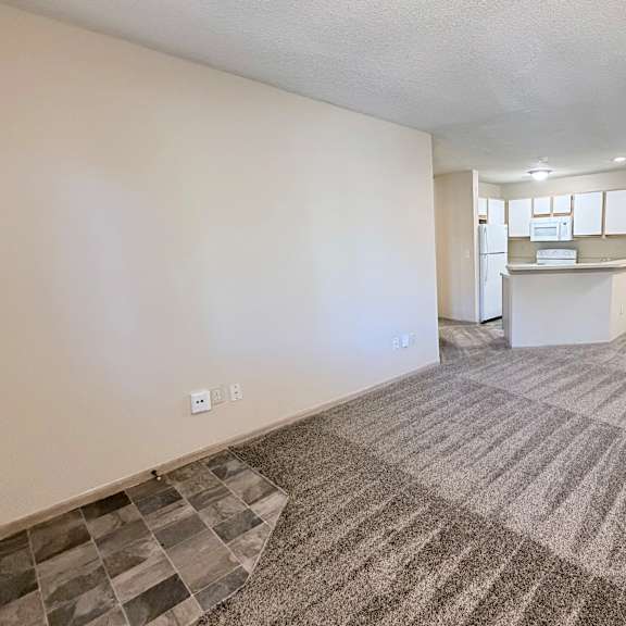 a room with a carpeted floor and a ceiling fan.