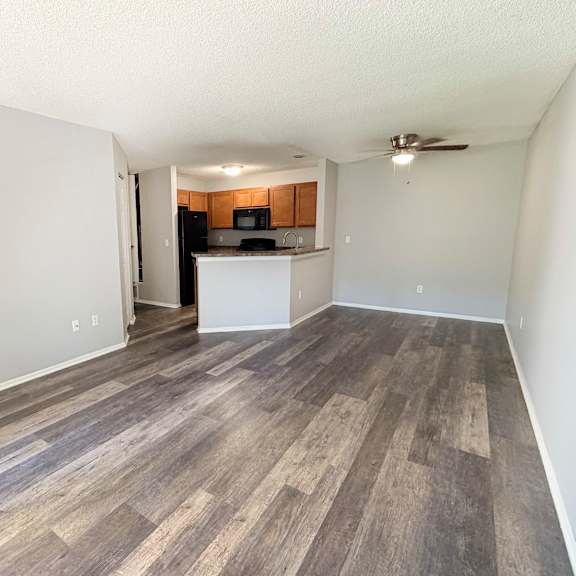 a room with wooden flooring and a ceiling fan.