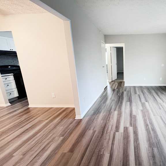 a room with wooden flooring and white walls.