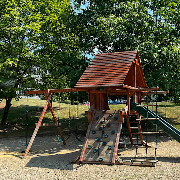 a playground with a swing set and a slide at deercross apartments, ohio