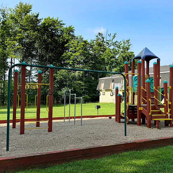 a playground with a swing set and a slide.