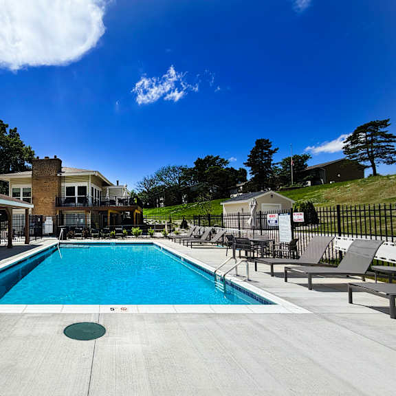 a large swimming pool with a building in the background.