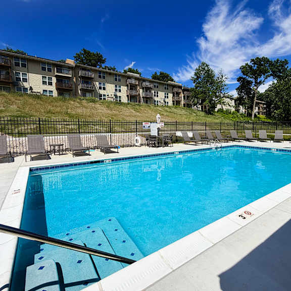 a large swimming pool with a metal railing around it.