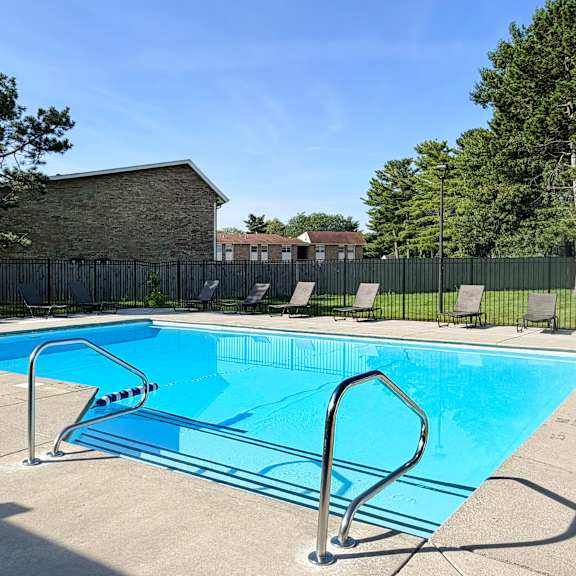 a small pool with a diving board in the foreground.
