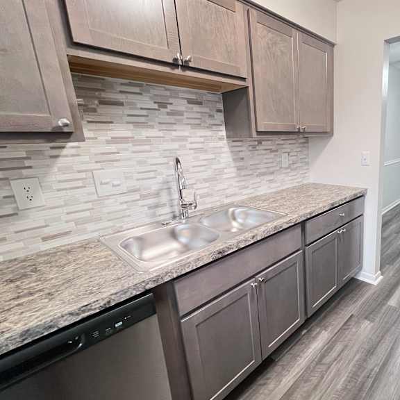 a kitchen with a sink and a refrigerator.