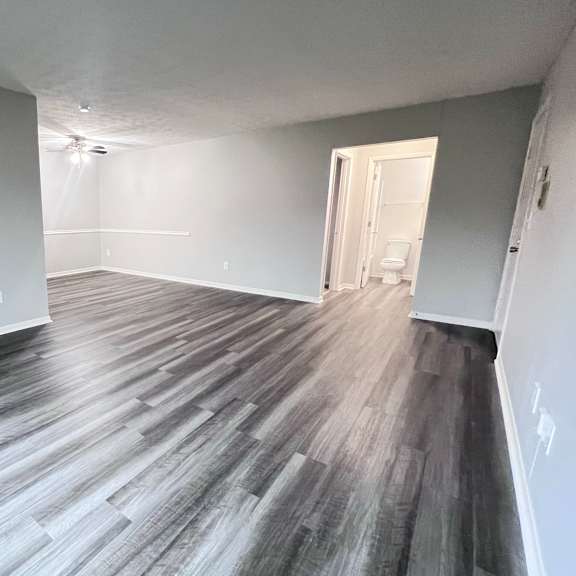 a room with a wooden floor and white walls.