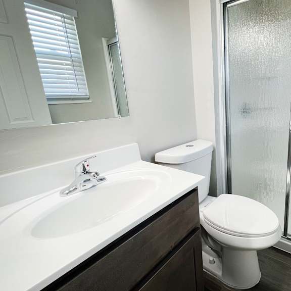 an empty bathroom with a shower toilet and sink at revere village apartments, centerville, oh, 45458