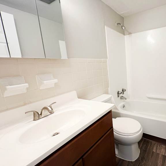 a white sink and toilet in a bathroom.