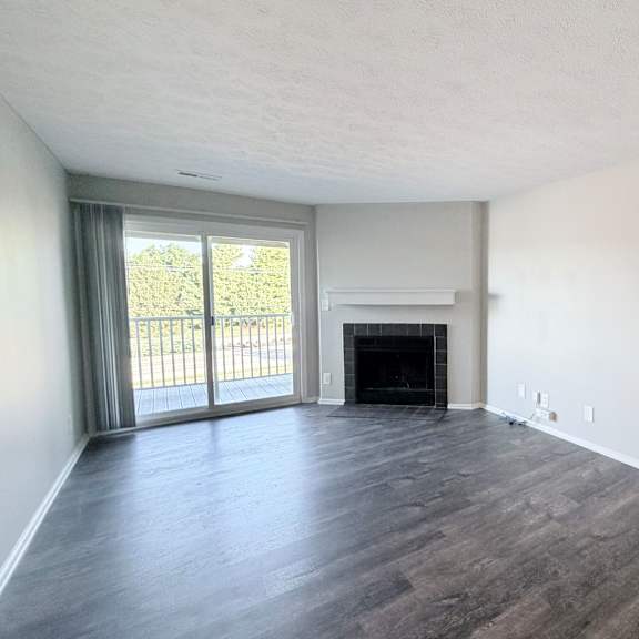 a room with a fireplace and sliding glass doors.
