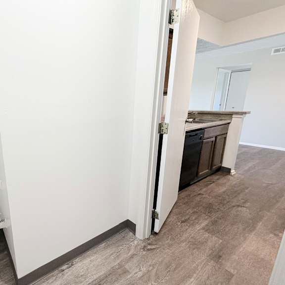 a white shelving unit in a room with a grey floor.