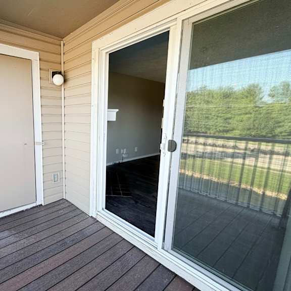 a screened door on a porch with a white frame.