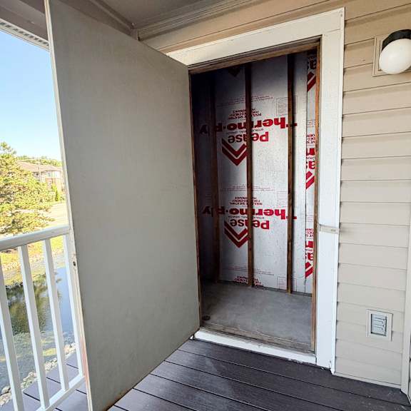 a house under construction with a sign on the door.