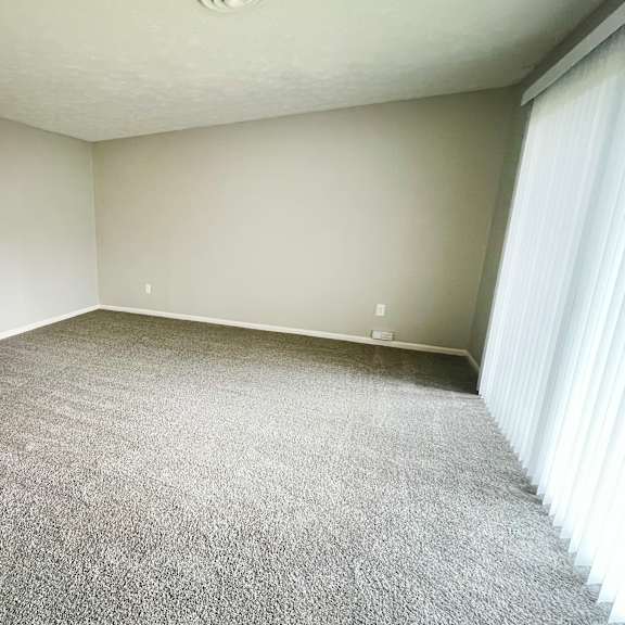 a room with a carpeted floor and white walls.