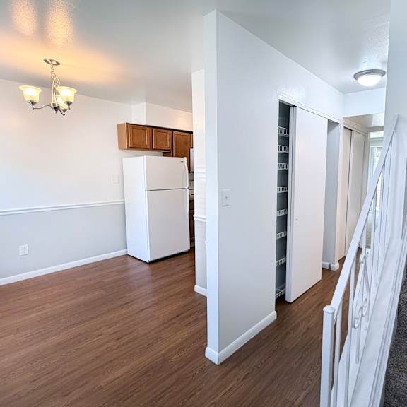a staircase with a carpeted runner leads up to a second floor.