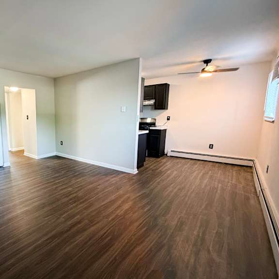 a room with wooden flooring and a ceiling fan.