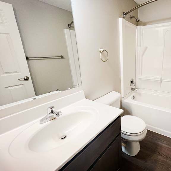 a bathroom with a sink toilet and a tub at woodhills apartments, ohio